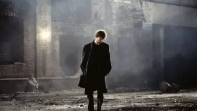 David Thewlis stands in a dark London street in the film, Naked by writer-director Mike Leigh.