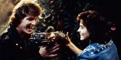 Robert Duncan McNeill, as Kevin Corrigan, admires the Cosmic Key in the film Masters of the Universe, with Courteney Cox.