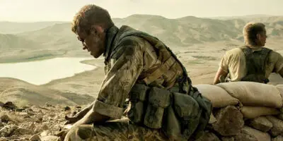 A British soldier in desert military uniform, looking tired and dirty, in the film Kajaki - The True Story.