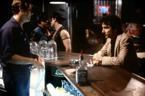 Griffin Dunne sits on a bar stool in a New York bar late at night in the film, After Hours.