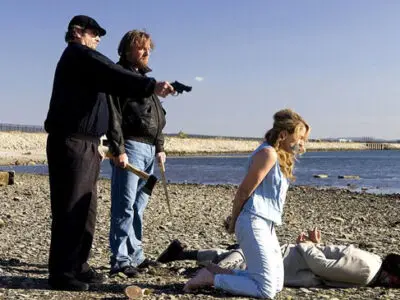 Jack Nicholson appears in the Martin Scorsese film The Departed holding a pistol over a kneeling woman on a beach.