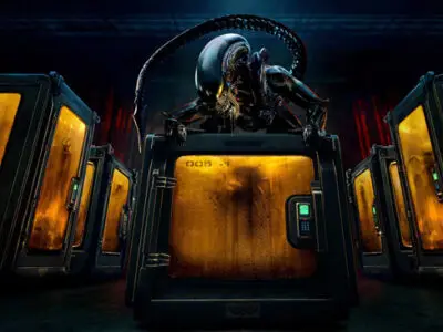 An alien creature - the familiar xenomorph known to fans of Ridley Scott's 1979 sci-fi horror Alien and later James Cameron's Aliens - sits on top of pods containing other malevolent alien creatures in a dark, low-lit image from the TV series, Alien: Earth.