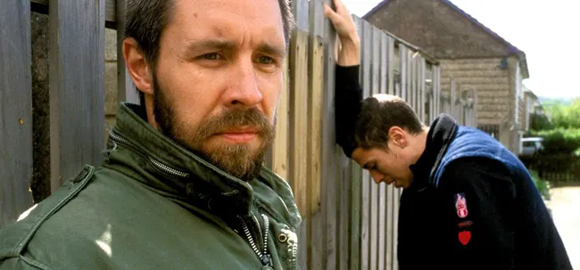 Paddy Considine in a faded green jacket, sporting a trimmed beard and looking angry in Shane Meadow's film, Dead Man's Shoes.