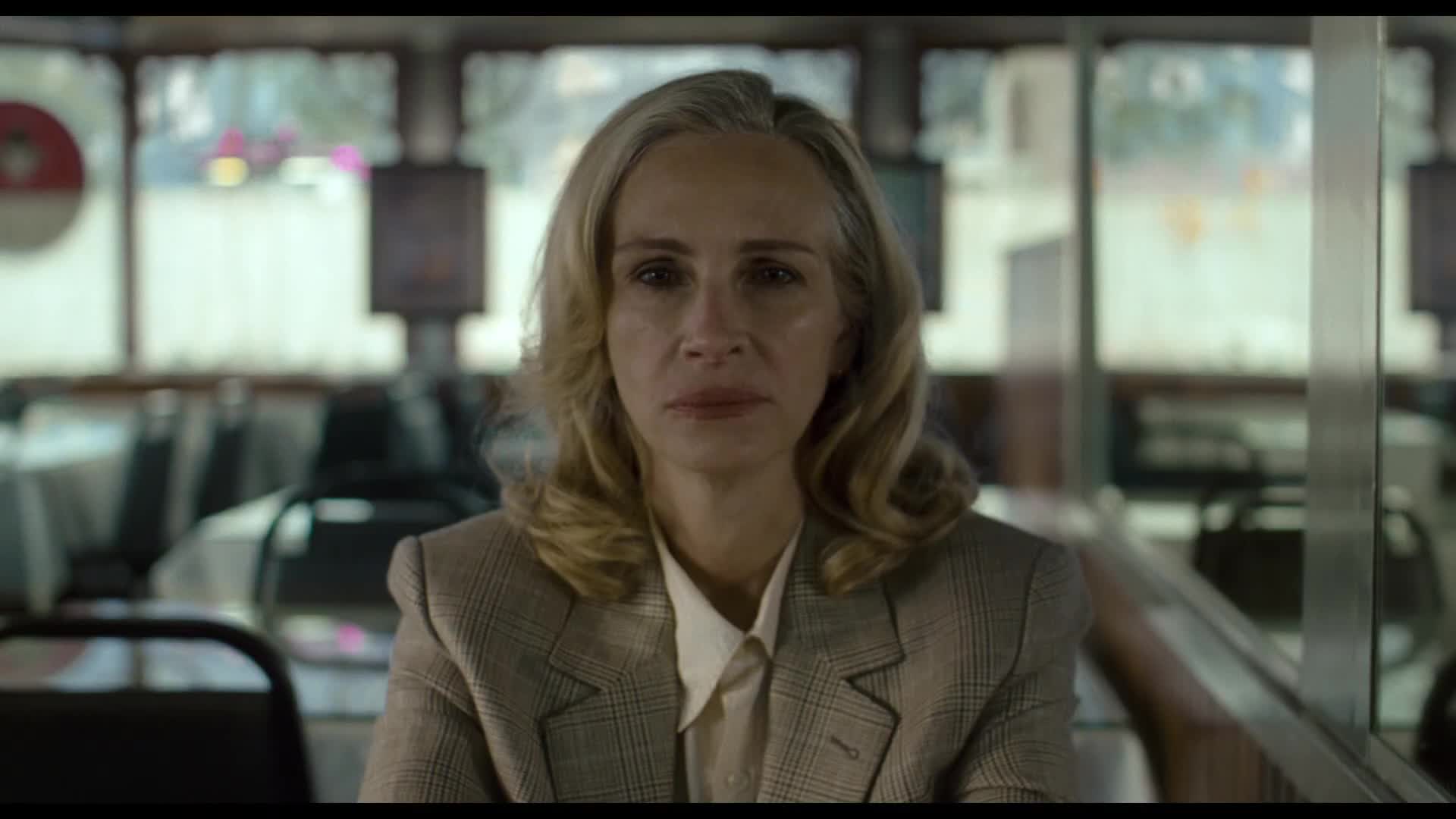 Julia Roberts, with blonde hair, stares directly at the camera in the film, After the Hunt.